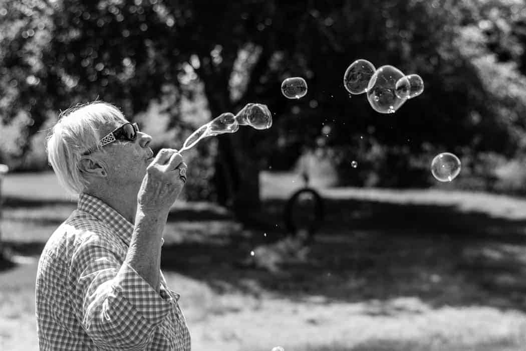 Grandparent Blowing Bubbles Black and White Elderly Fun