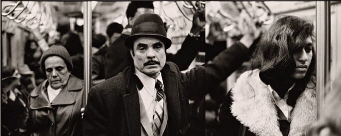 Hispanic man with hat, glamourous young woman with fur collar photography black and white silvertype